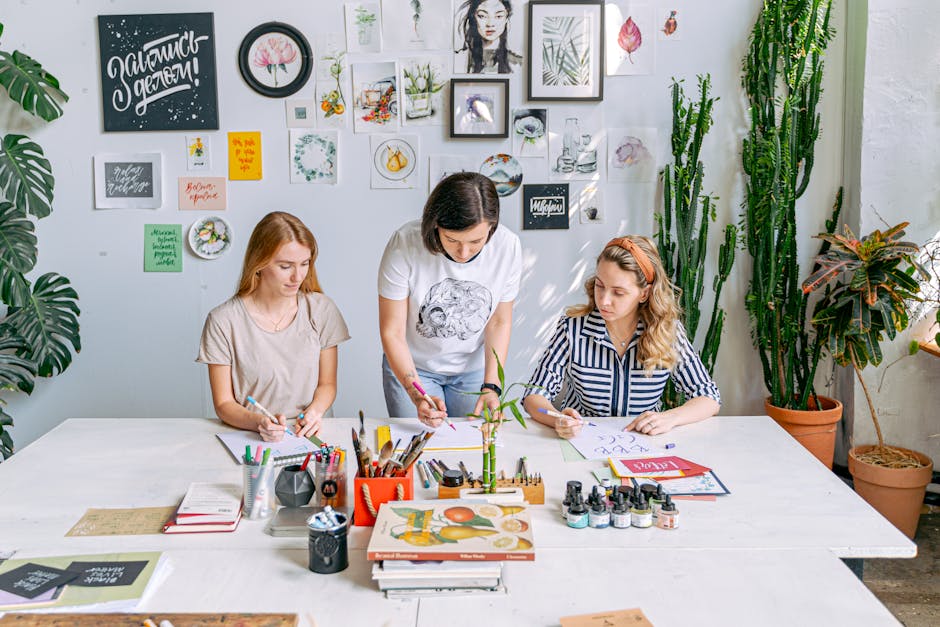 Art class scene with students and instructor working on creative projects in a bright, indoor studio.