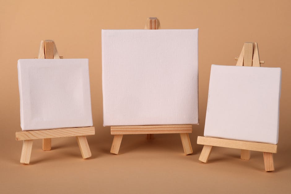 Three blank canvases on wooden easels, perfect for art, design, and creativity projects.